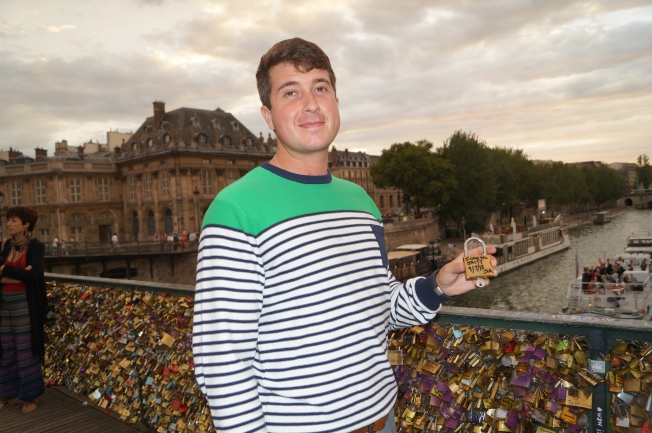 Josh getting ready to throw his key into the Seine River.